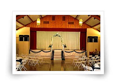 Hall interior with stage decorated for wedding